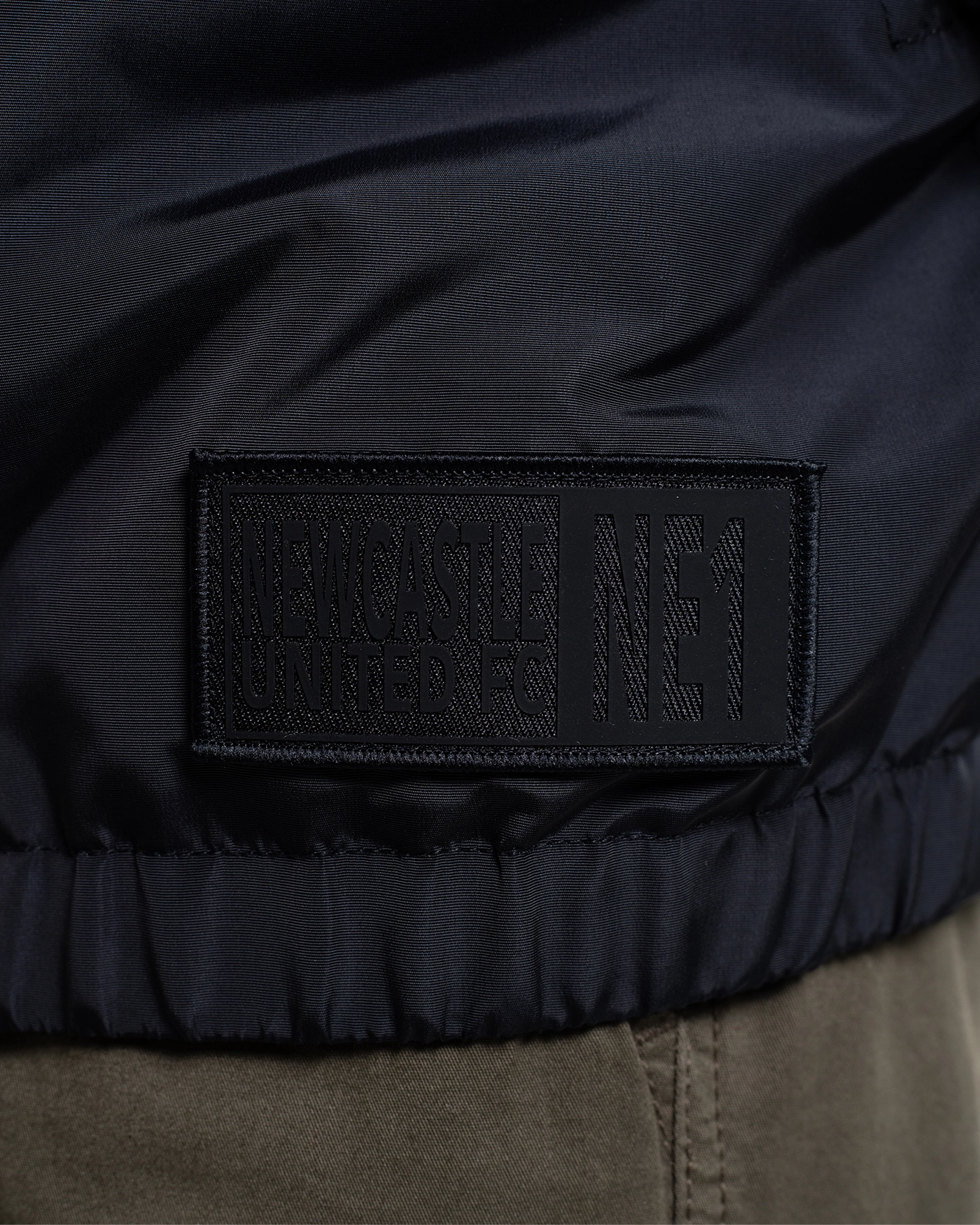 Newcastle United Black Quarter Zip Cagoule