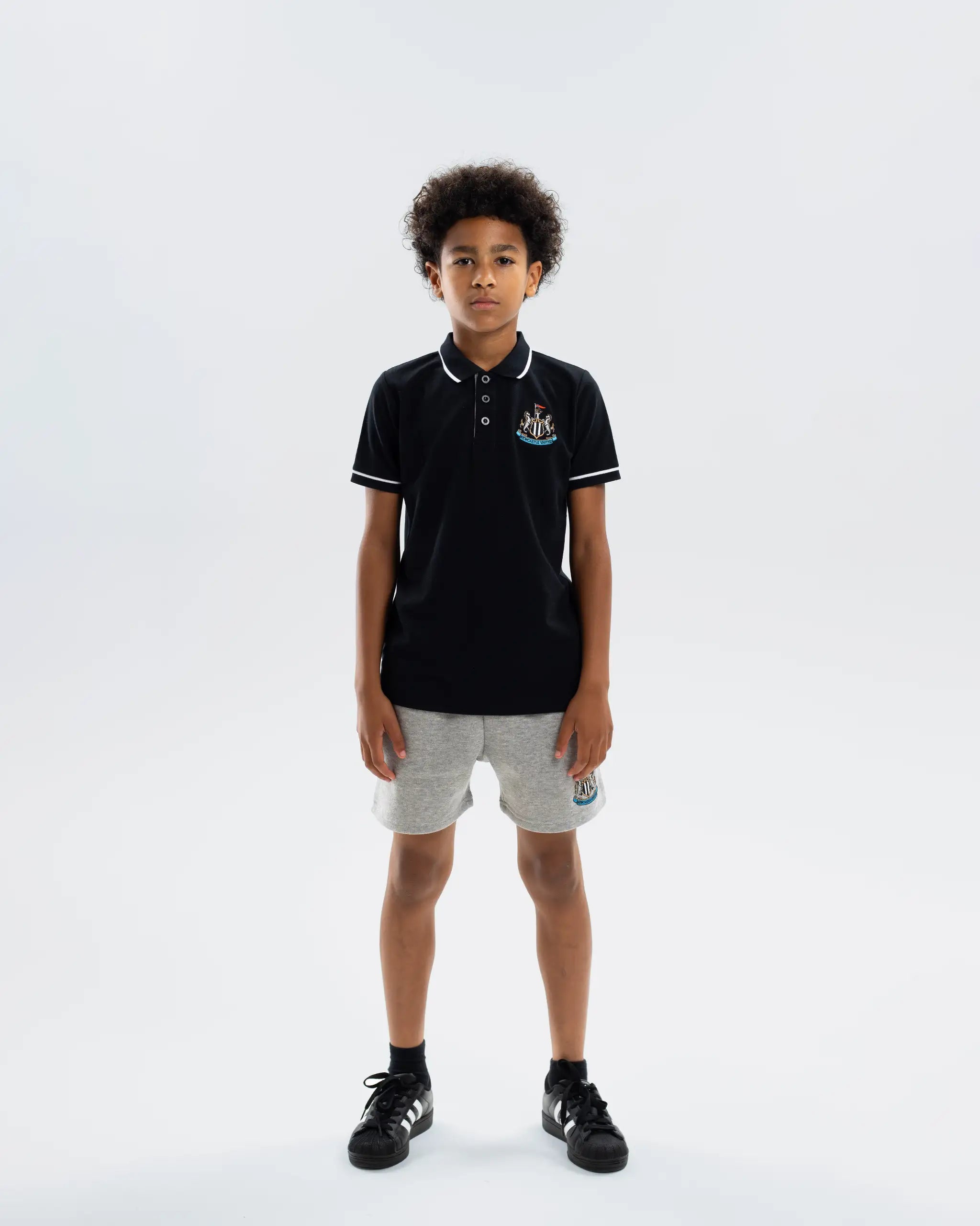 Newcastle United Kids' Essentials Range Black Polo Shirt