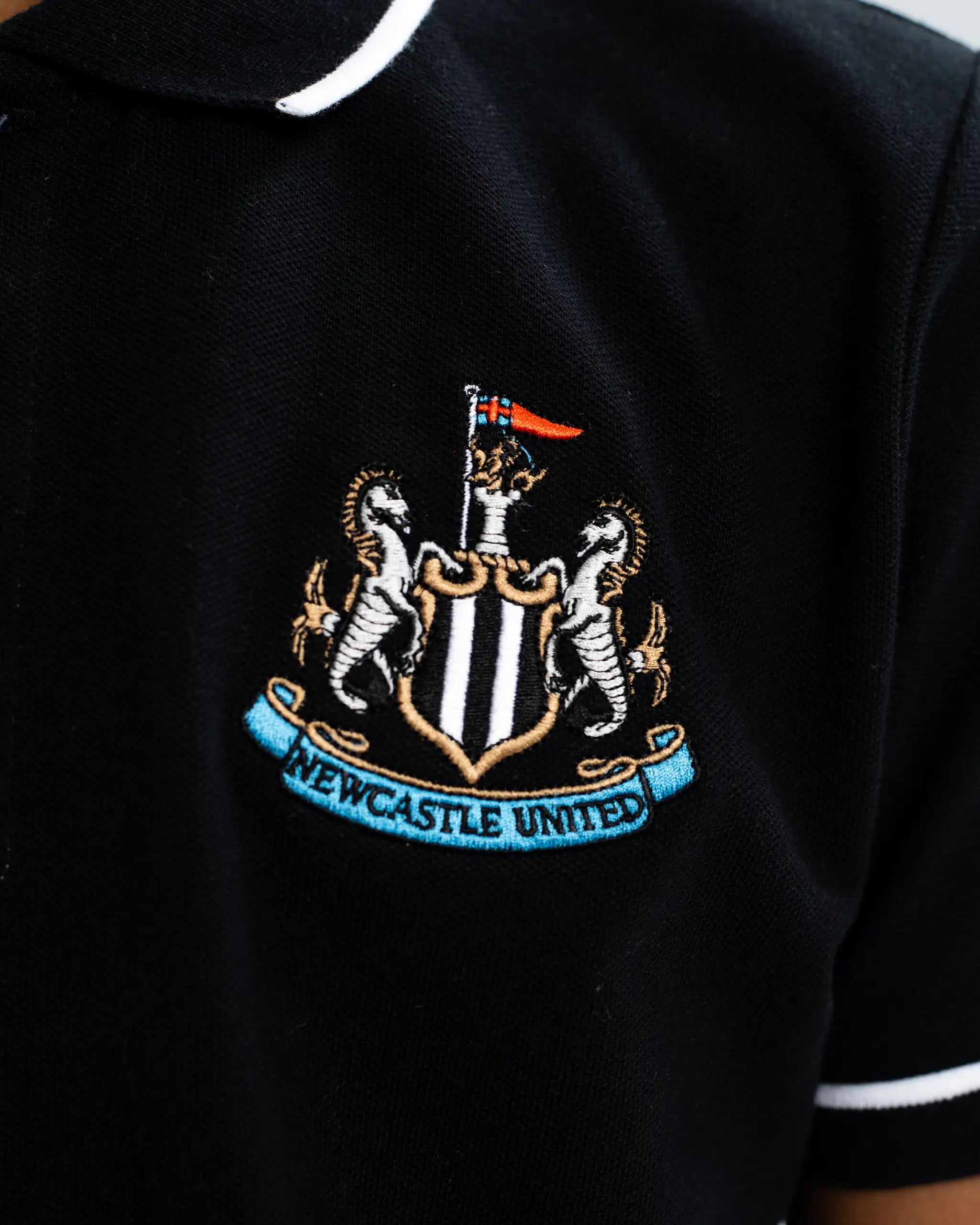 Newcastle United Kids' Essentials Range Black Polo Shirt